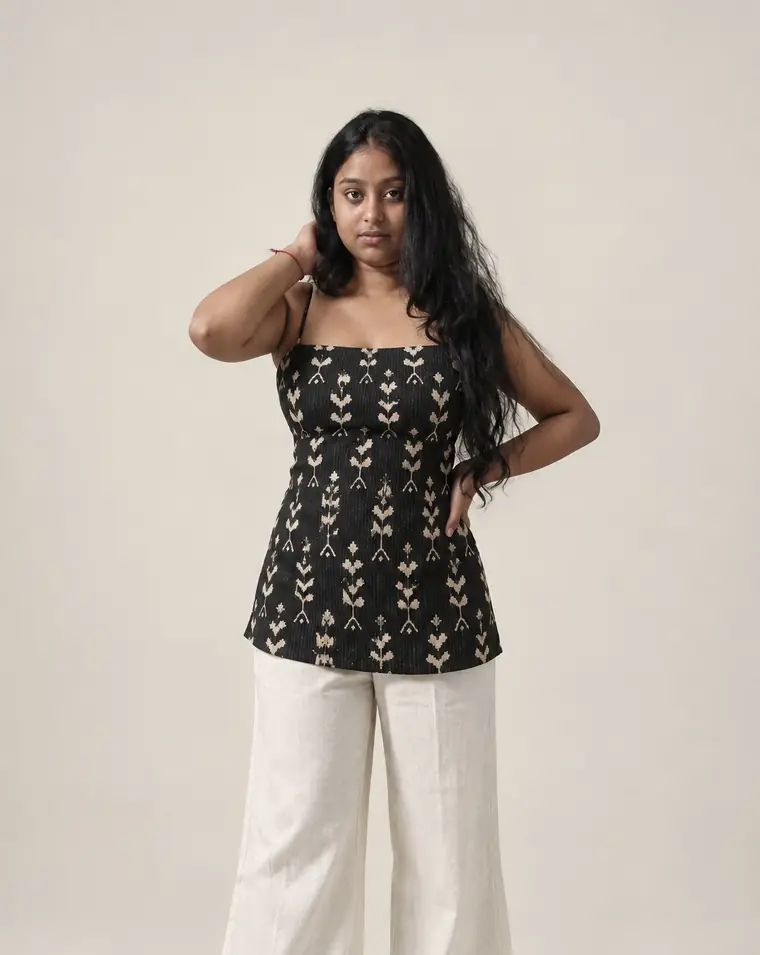 Black ikat-motif camisole top with kantha stitching, worn with ivory linen pants