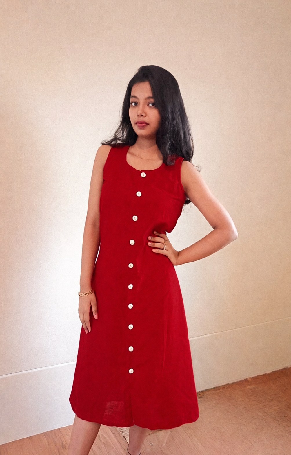 Model in the Noor red cotton midi dress, looking at the camera